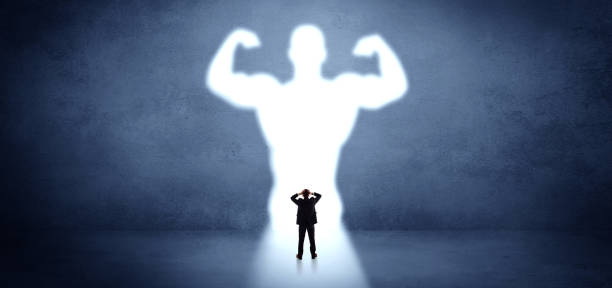 istock Businessman standing in front of a strong hero vision 1252627497
