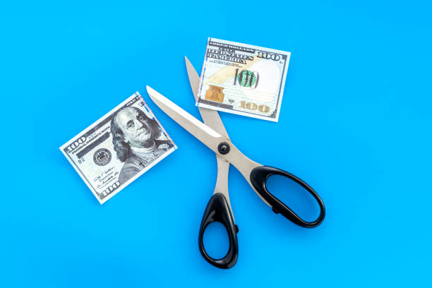 istock Decline of dollar exchange rate. Scissors cut dollars banknote 1252630962