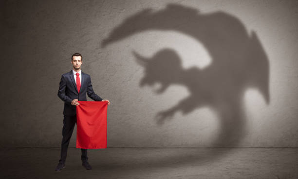 istock Businessman with imp shadow and toreador concept 1252638428