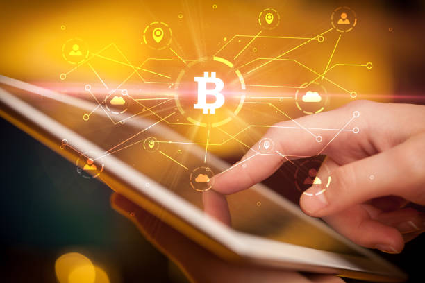Hand using tablet with bitcoin link network and online concept Hand using tablet with cryptocurrency bitcoin link network and online concept miner photos stock pictures, royalty-free photos & images