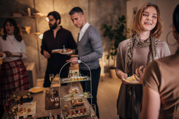 istock Business people sampling savory dishes from buffet table at office party 1252648052