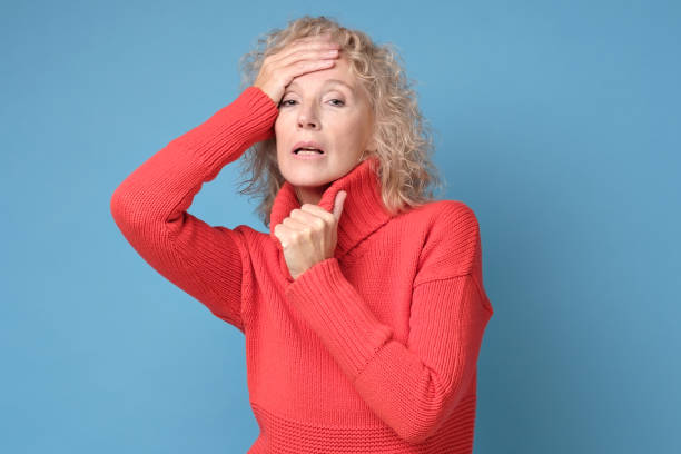 istock Sick exhausted female touching forehead, having fever or headache 1252651342