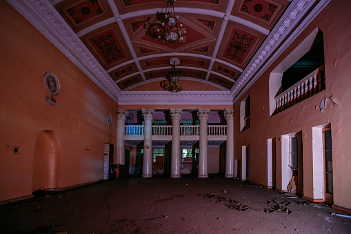 Old dark creepy abandoned ruined haunted theater hallway.