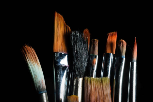istock Paint brushes of different size are kept side by side in a dark background 1252660127