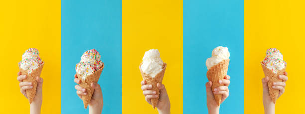 niño sosteniendo un cono de helado de vainilla sobre un fondo amarillo y azul brillante. bandera - espolvorear fotografías e imágenes de stock