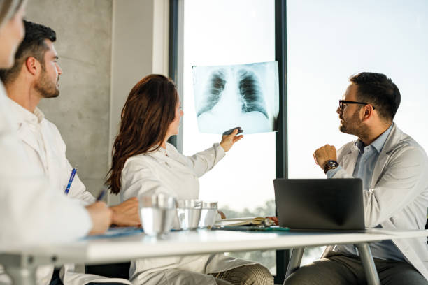 istock Team of doctors analyzing X-ray image of lungs in the office. 1252663751