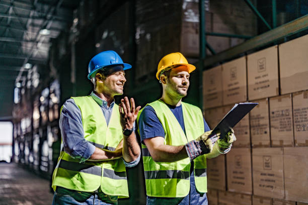 istock Warehouse worker and his manager going through checklist in a storage room. 1252666727