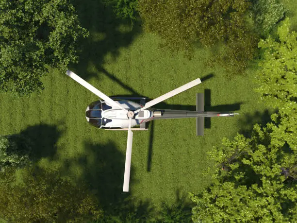A helicopter is standing on the grass in a top view. Helipad in the forest among the trees. Aerial view. 3D render