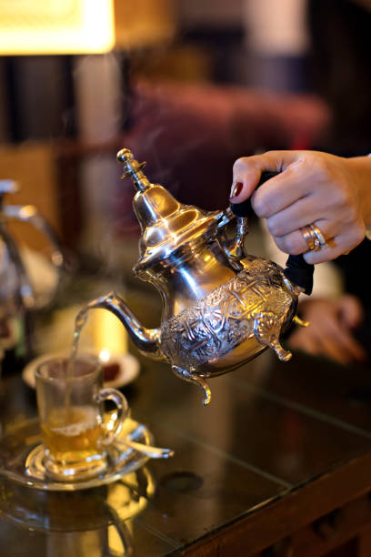 istock Pouring Tea into Tea Cup on Wooden Table 1252668321