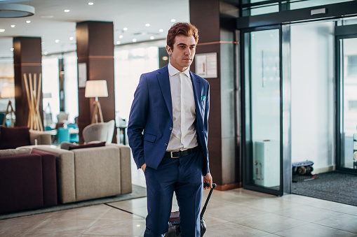 One young businessman arriving at a hotel lobby.