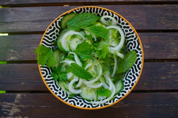 istock Pickled cucumber salad  with mint, onions, chilli, dill and parsley 1252673192