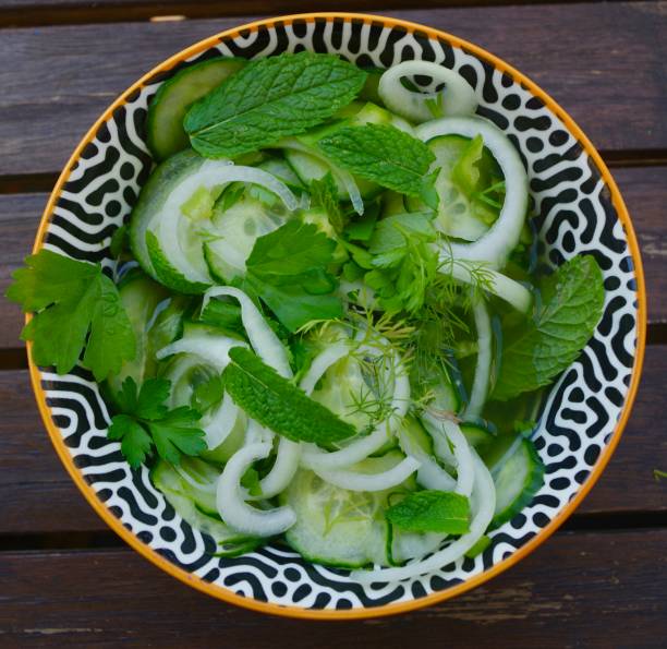 istock Pickled cucumber salad  with mint, onions, chilli, dill and parsley 1252673194