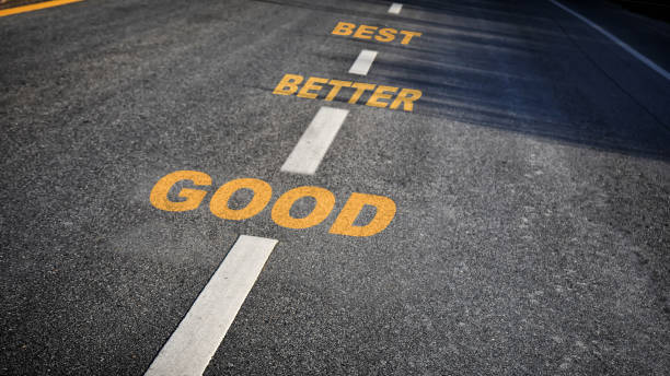 Good, better and best words on asphalt road stock photo