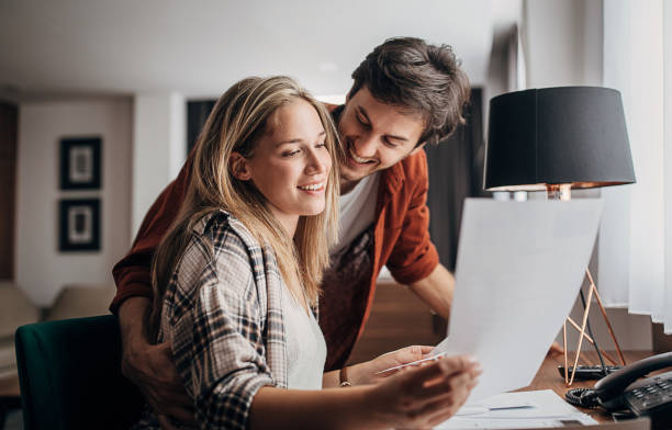 istock One beautiful young couple reading a guide in a hotel room 1252673336