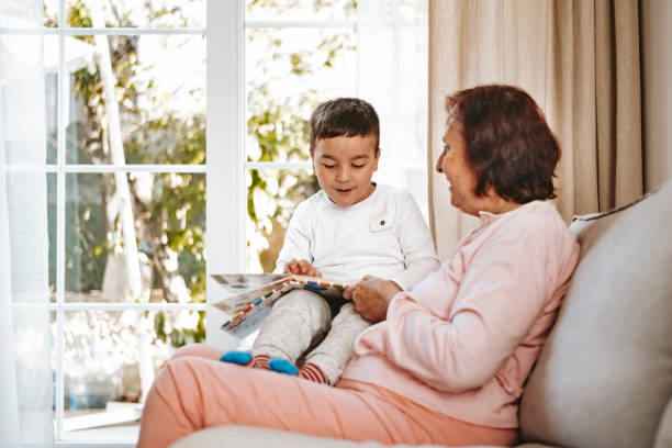 istock Grandmother reading a book for her small grandson 1252675264