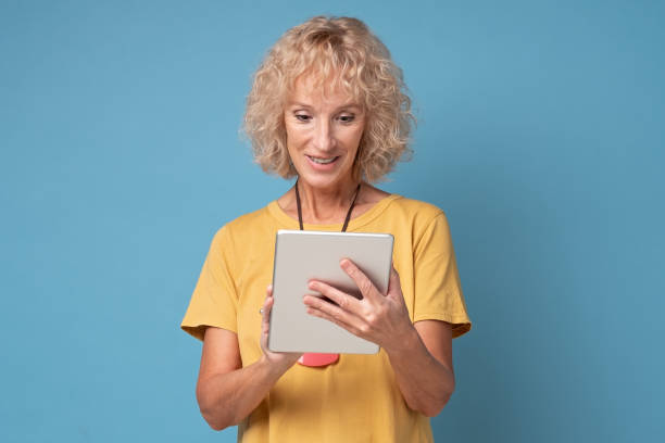 istock woman using a tablet computer selecting goods in online shop 1252676961