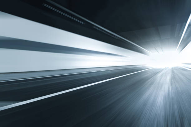 istock motion blurred asphalt road in tunnel with copy space. 1252677059
