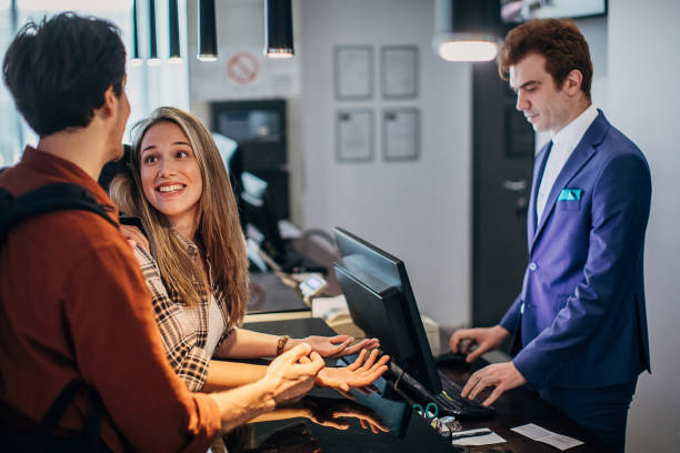 istock Beautiful young couple doing the check-in at a hotel reception 1252678756