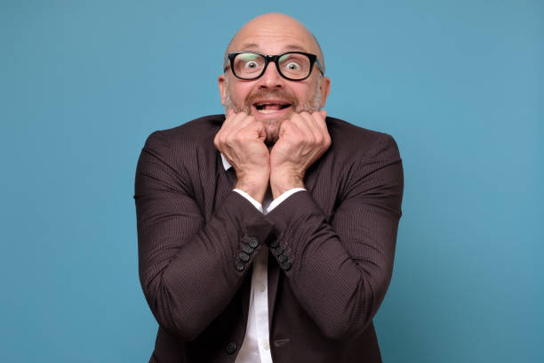 istock Handsome man looks with excitement clapping hands,receiving a great news 1252680713