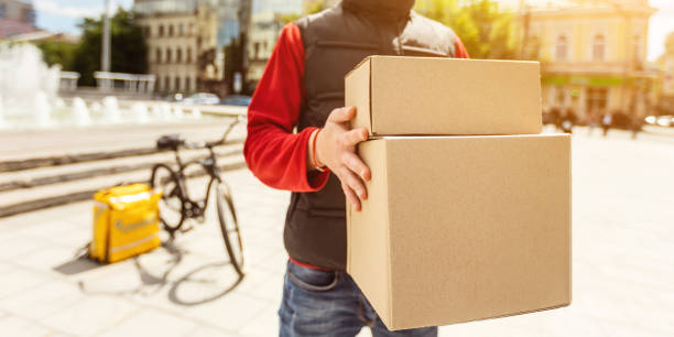 istock Unrecognizable Courier Delivering Packages And Food Outdoors, Cropped, Panorama 1252680741