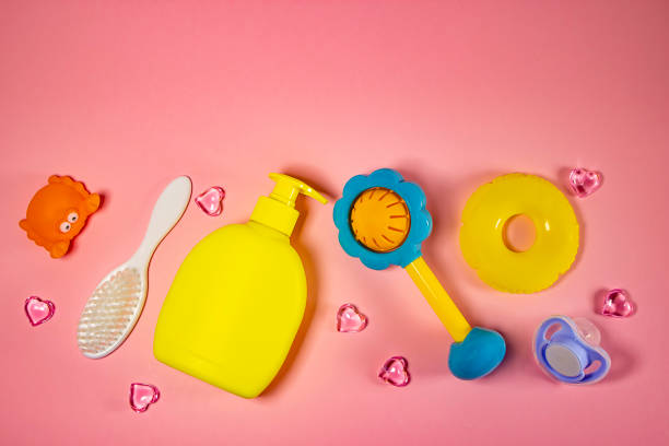 istock Children's hygiene: bath items, shampoo bottle, rubber toy, sponge, comb, thermometer, safety scissors top view, on a pink background. Children's personal care kit. Bath accessories. 1252682585