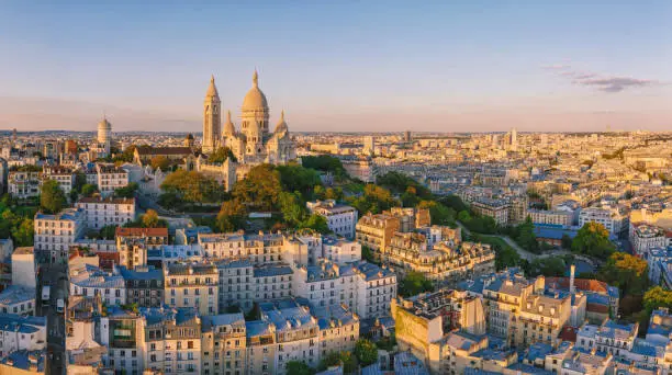 Photo of Montmartre hill with Basilique du Sacre-Coeur in Paris at sunset, aerial view