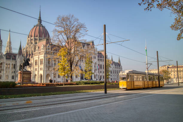 istock Square before Hungarian paliament building with moving tram in Budapest. 1252682766