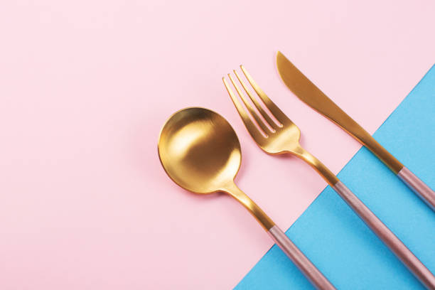 istock Beautiful cutlery set on pink and blue background. 1252682930
