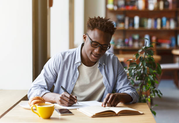 istock Young African American man studying in modern cafe 1252683153