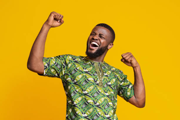 istock Black man showing positive emotions over yellow background 1252683175