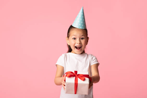 istock Happy asian girl holding gift box at studio 1252683241