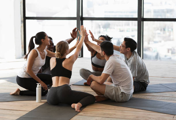 istock Yoga Class Members Giving High Five To Each Other After Training 1252685214
