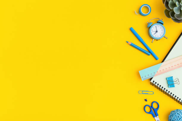 istock Blue stationery on yellow background. Creative flat lay. Back to school concept. 1252686039