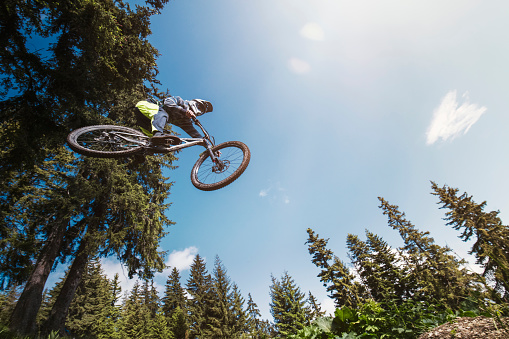 Sport. Cyclist against the sky. A young man rides a mountain bike in beautiful nature.Downhill, MTB. Extreme sport.