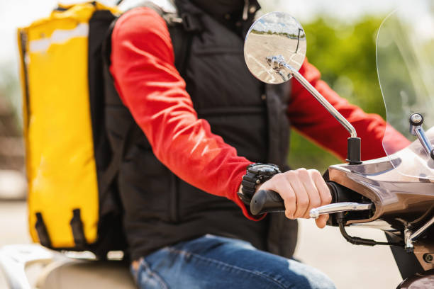 istock Courier With Yellow Backpack Delivering Food On Scooter Outdoors, Cropped 1252687072