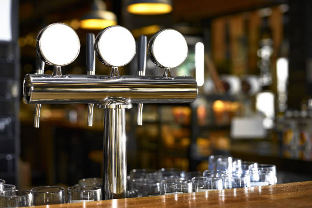 Beer tap in bar, mock up with selective focus. Beer tap in bar, mock up with selective focus. restaurant blur on the background beer pump stock pictures, royalty-free photos & images