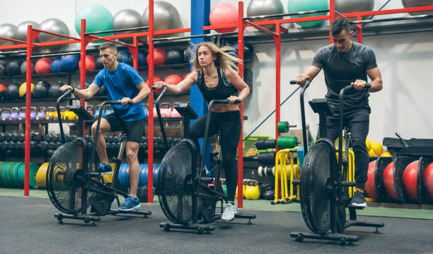 istock Athletes doing air bike indoor 1252689006