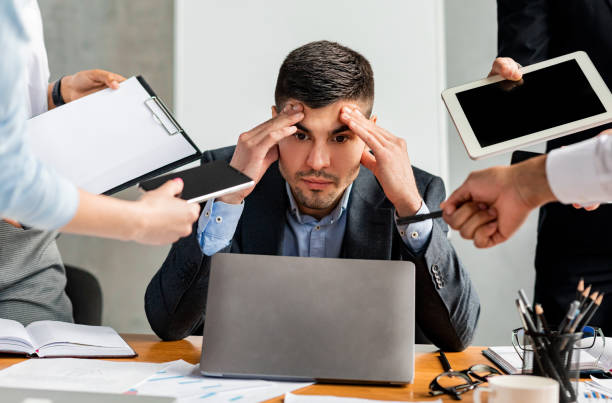 istock Stressed Businessman Tired Of Tasks Sitting At Work In Office 1252690405