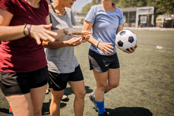 istock Female soccer players talking about tactics before training 1252691331