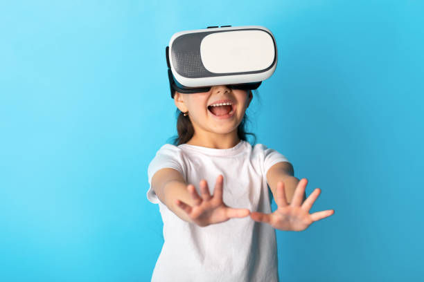 istock Little girl wearing virtual reality goggles at the studio 1252691529