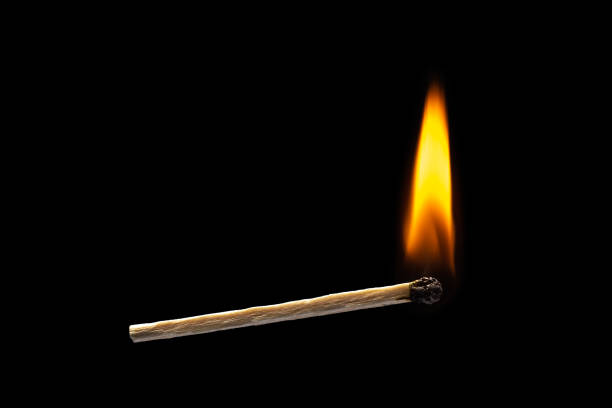 istock Orange fire of matchstick on black background. horizontal 1252691925