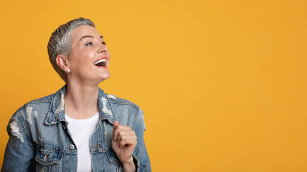 istock Great Offer. Excited Middle-Aged Lady Looking At Copy Space On Yellow Background 1252697420