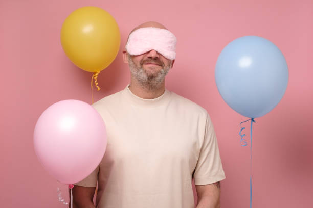 istock Mature man in sleeping mask resting after party 1252697478