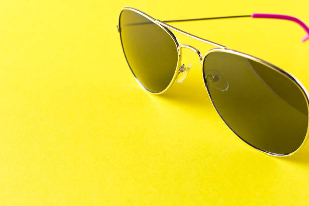 istock Sunglasses on a yellow background. Close up. 1252697605