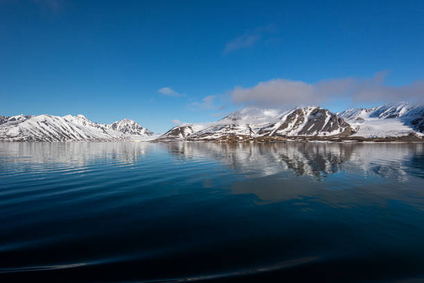 Spectacular panorama view of Wilhelmoya island with mountain range and blue sky. Torellneset, Nordaustlandet Spitsbergen, Norway. Tourism and vacations concept.