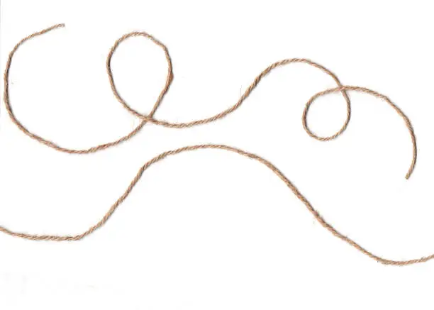 Long rough brown rope on white background.