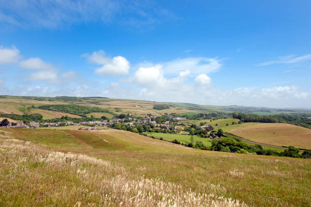 istock English village over fields, Dorset Ridgeway, Jurassic Coast, Dorset, England 1252700274