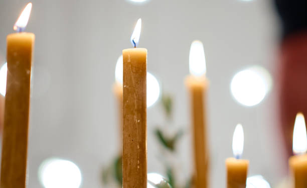 istock Beautiful burning candles and fairy lights at table with bokeh 1252701708