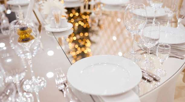 istock Served mirrored table with plates of wine glasses and dining appliances 1252701712