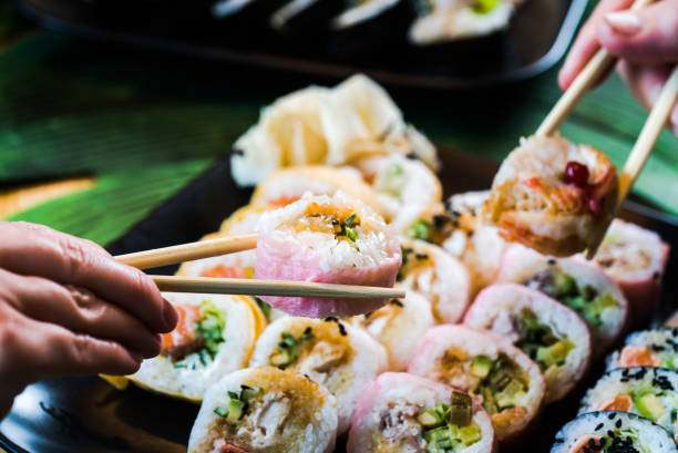 istock Sushi and roll set on wooden table. Selective focus 1252701807